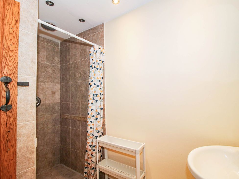 A bathroom with a shower and sink at The Duck House at Hyssington Farm near Montgomery