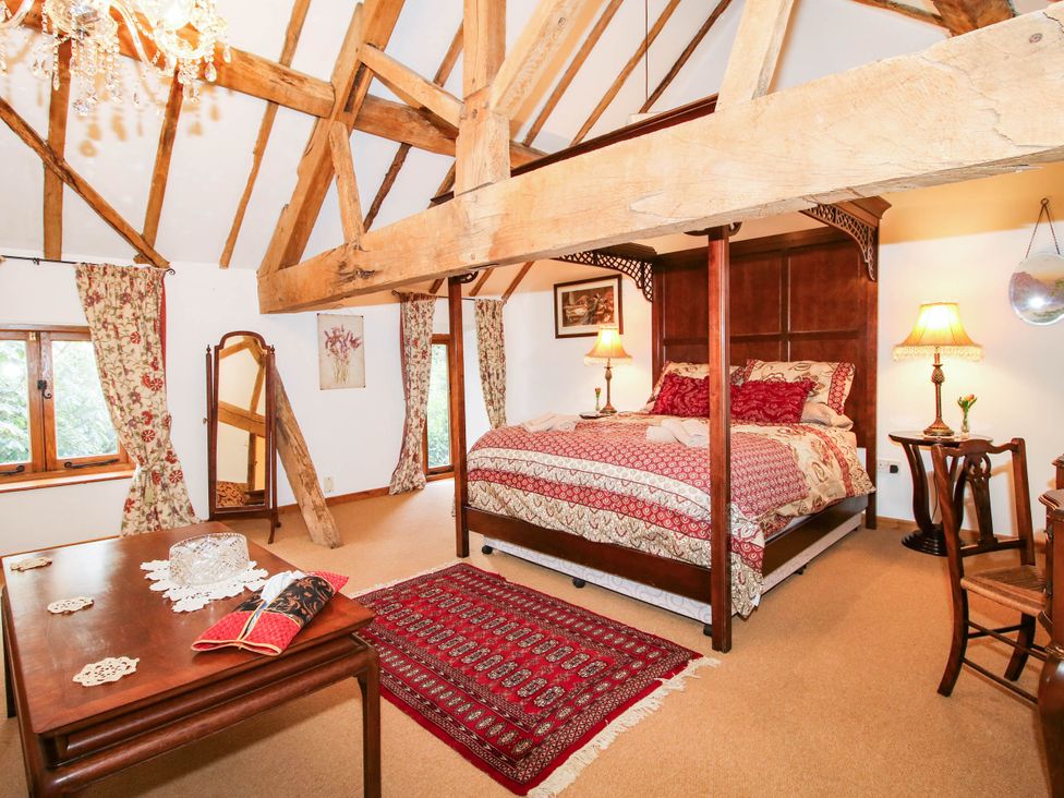 A bedroom with a bed and table at The Duck House at Hyssington Farm near Montgomery