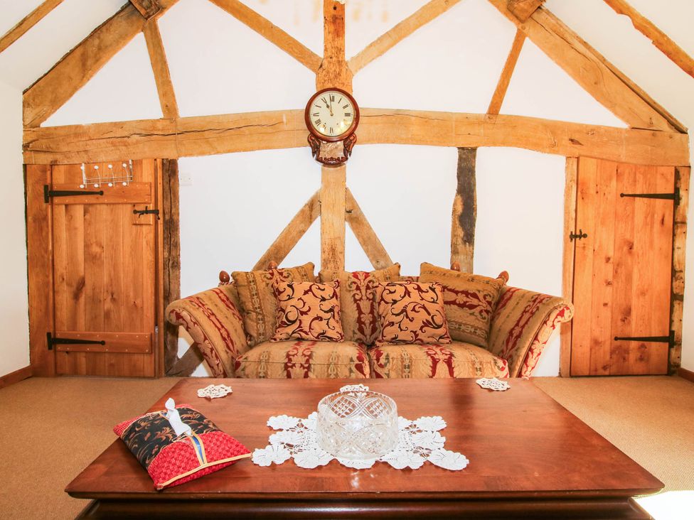 A sitting room with a sofa and wooden table at The Duck House at Hyssington Farm near Montgomery