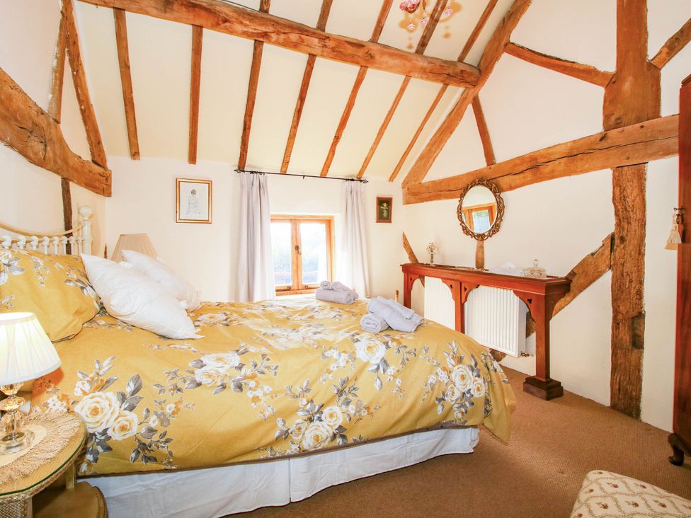 A bedroom with a bed and window at The Duck House at Hyssington Farm near Montgomery