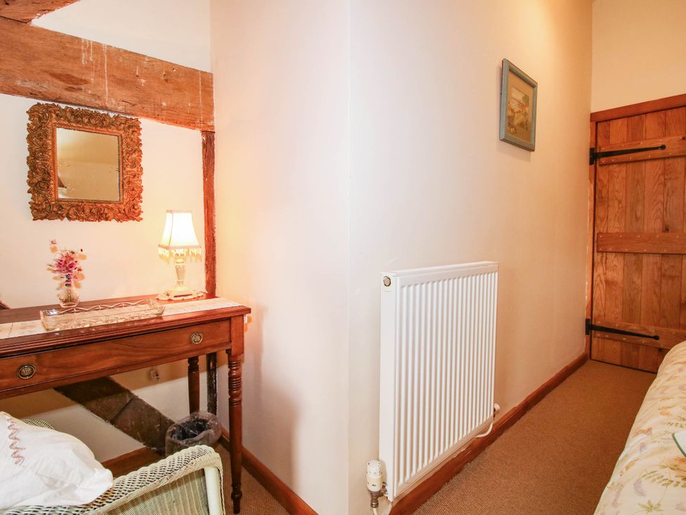 A hallway with a table and mirror at The Duck House at Hyssington Farm