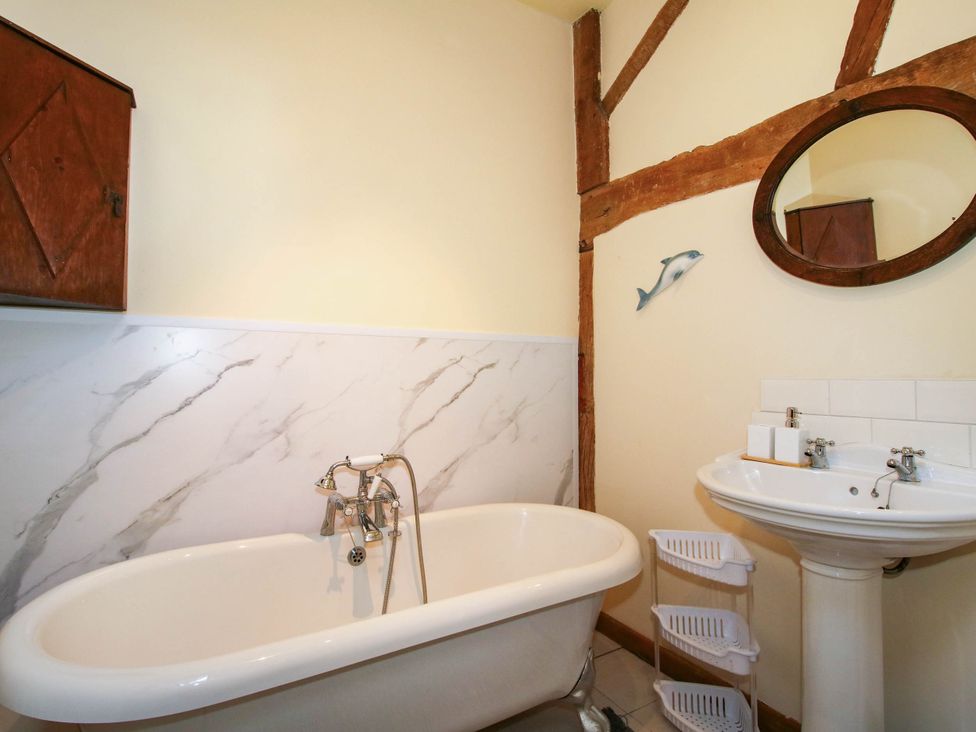 A bathroom with a bathtub and sink at The Duck House at Hyssington Farm near Montgomery