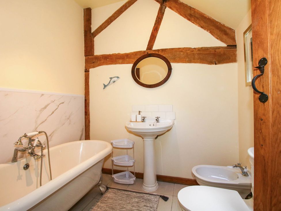 A bathroom with a bathtub, sink, and toilet at The Duck House at Hyssington Farm near Montgomery