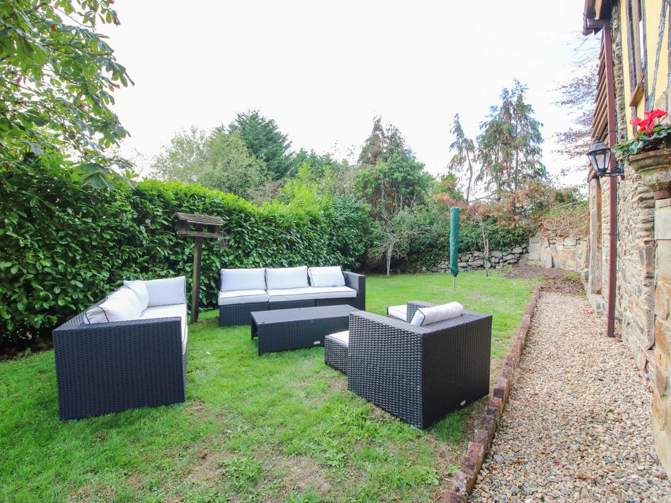 A garden with seating area and coffee table at The Duck House at Hyssington Farm near Montgomery