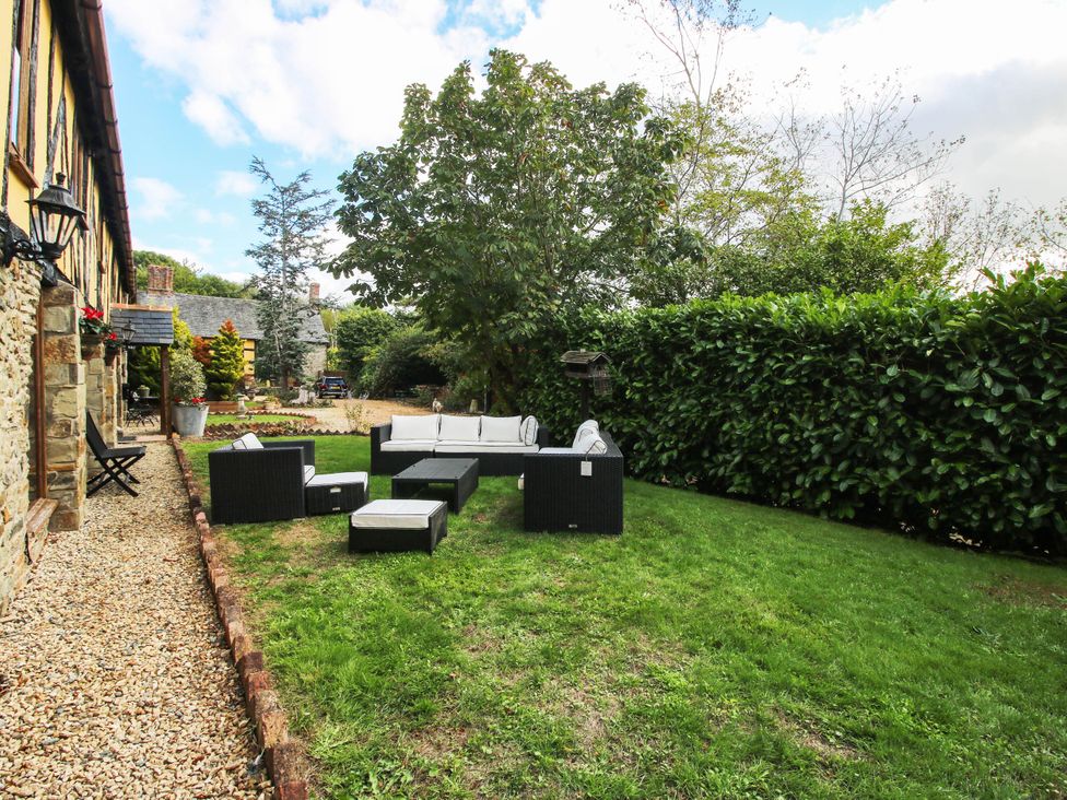 A garden area with seating and greenery at The Duck House at Hyssington Farm near Montgomery