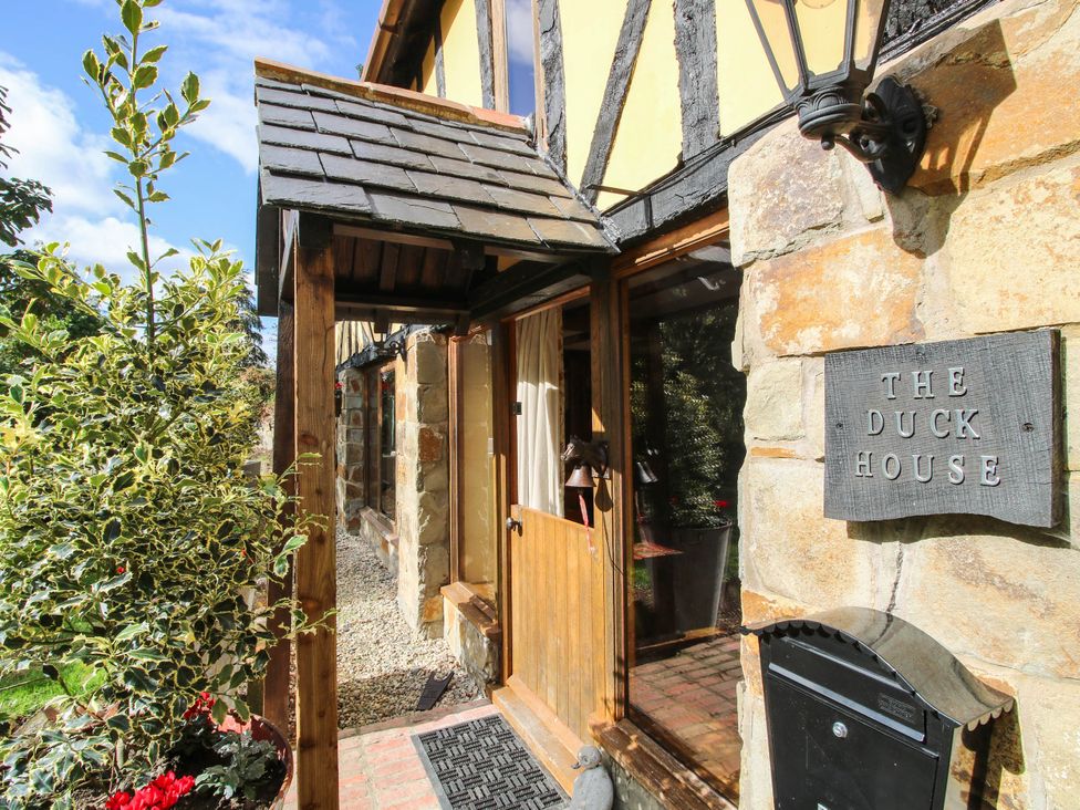 An entrance with plants and a sign at The Duck House at Hyssington Farm near Montgomery