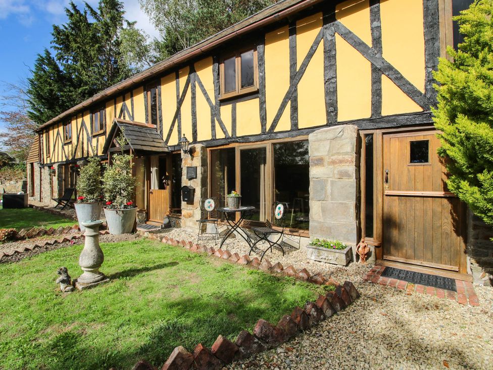 An outdoor view of a cottage with a garden at The Duck House at Hyssington Farm near Montgomery