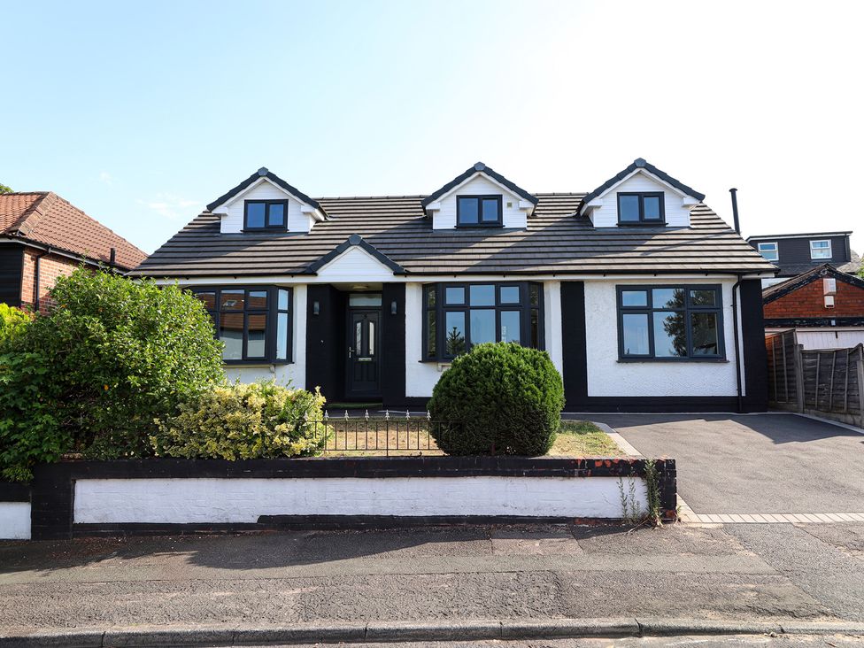 A house with a garden and driveway at 5 Woodland Crescent in Manchester