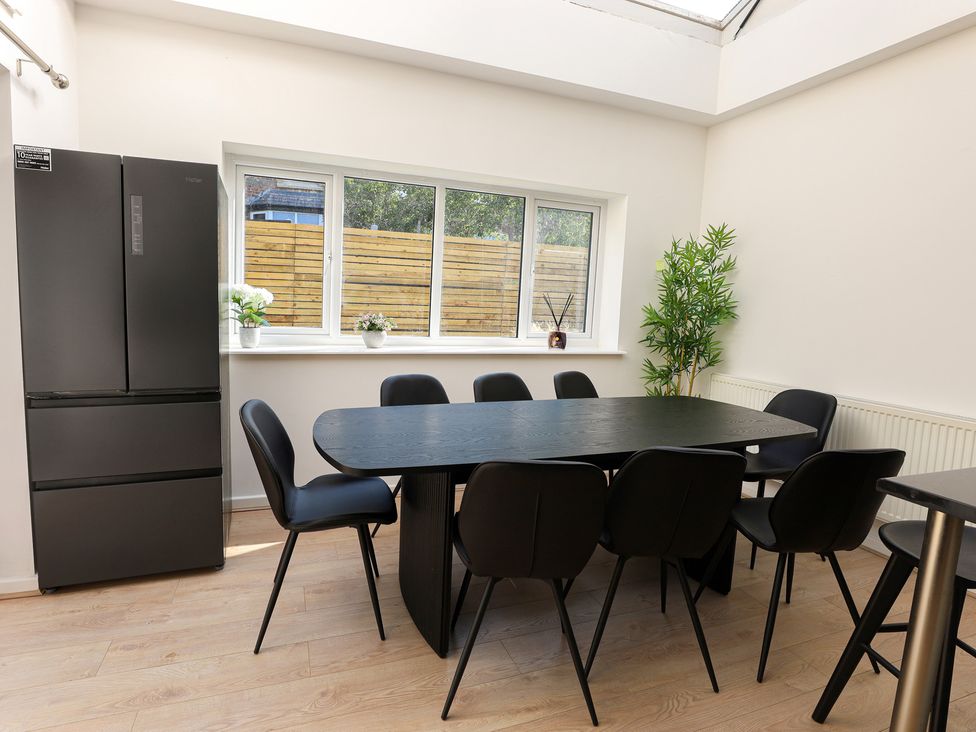 A dining room with a table and chairs at 5 Woodland Crescent in Manchester