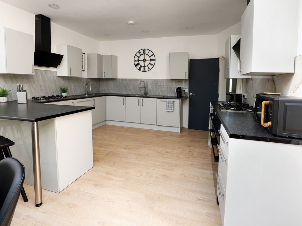 A kitchen with cabinets and appliances at 5 Woodland Crescent in Manchester