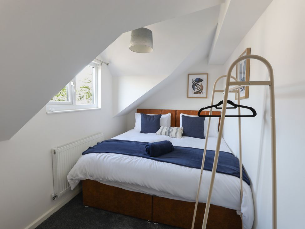 A bedroom with a bed and a clothes hanger at 5 Woodland Crescent in Manchester