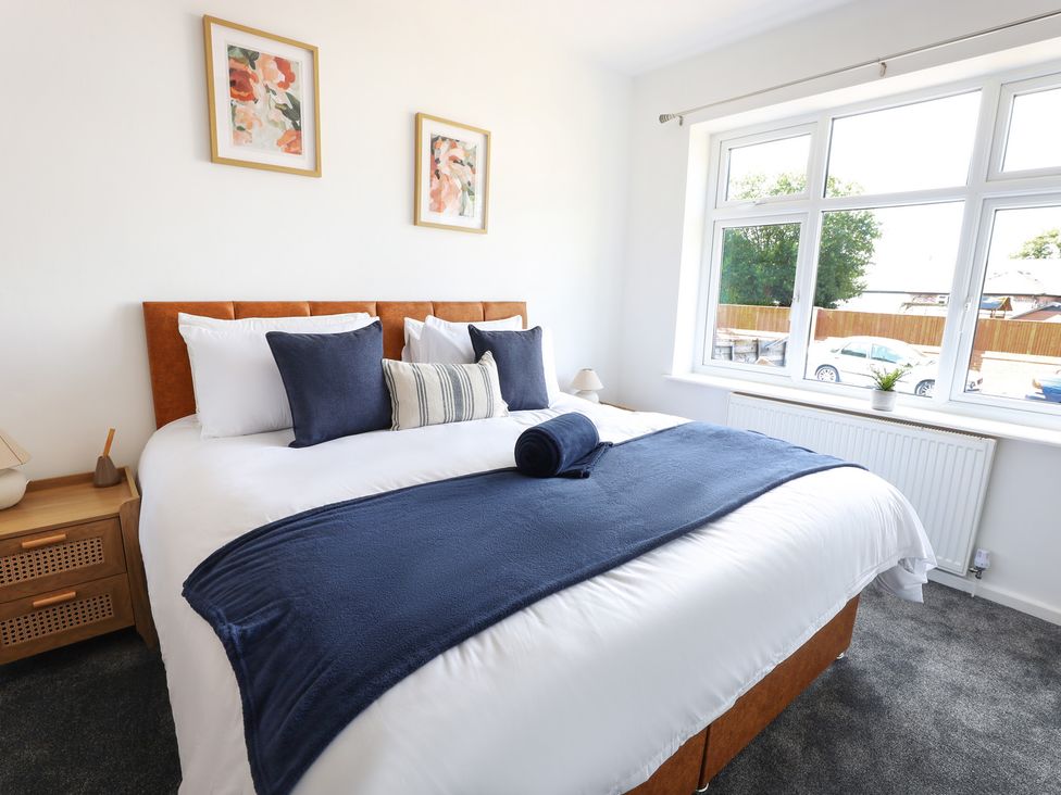 A bedroom with a bed and window at 5 Woodland Crescent in Manchester