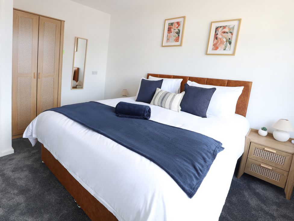A bedroom with a bed and wardrobe at 5 Woodland Crescent in Manchester