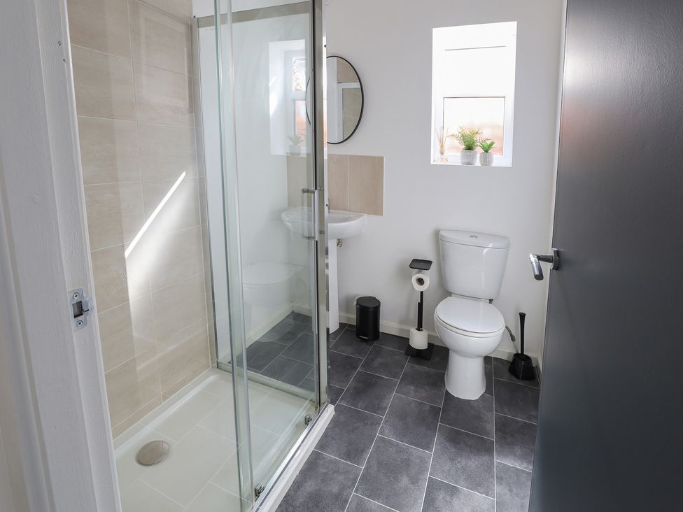 A bathroom with shower and sink at 5 Woodland Crescent in Manchester