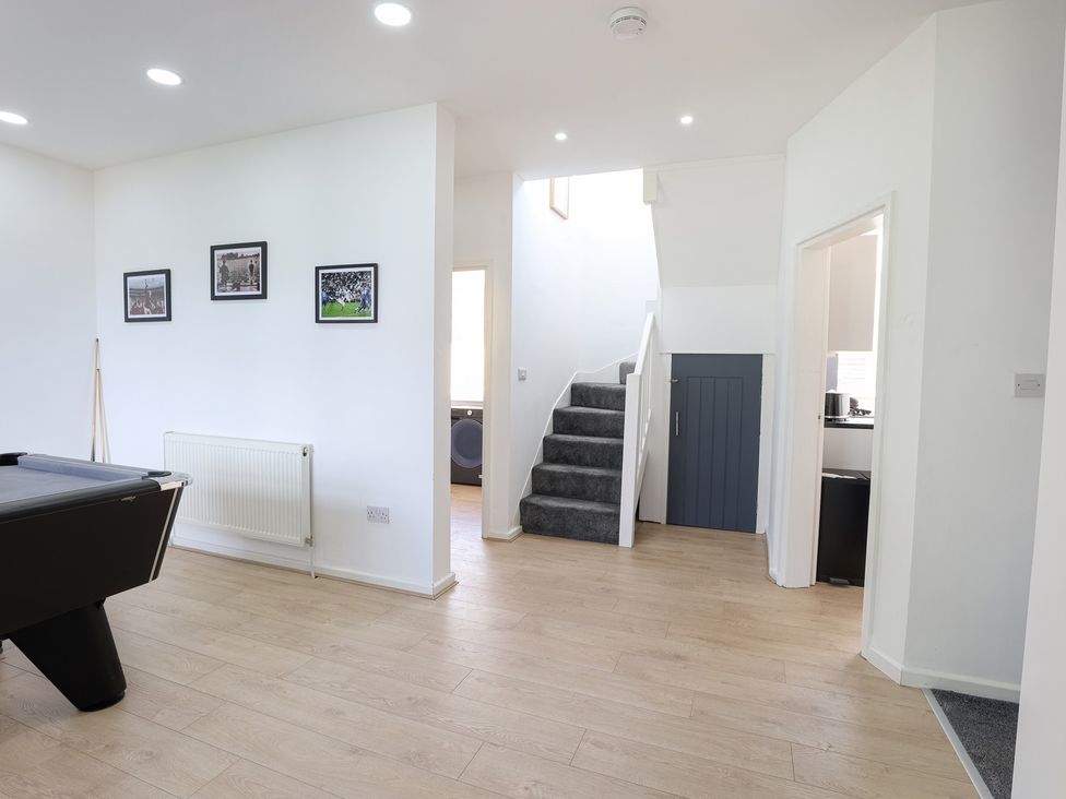 A recreation room with a pool table and photographs at 5 Woodland Crescent in Manchester