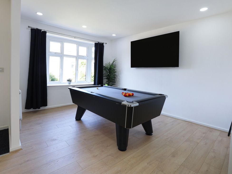 A games room with a pool table and television at 5 Woodland Crescent in Manchester
