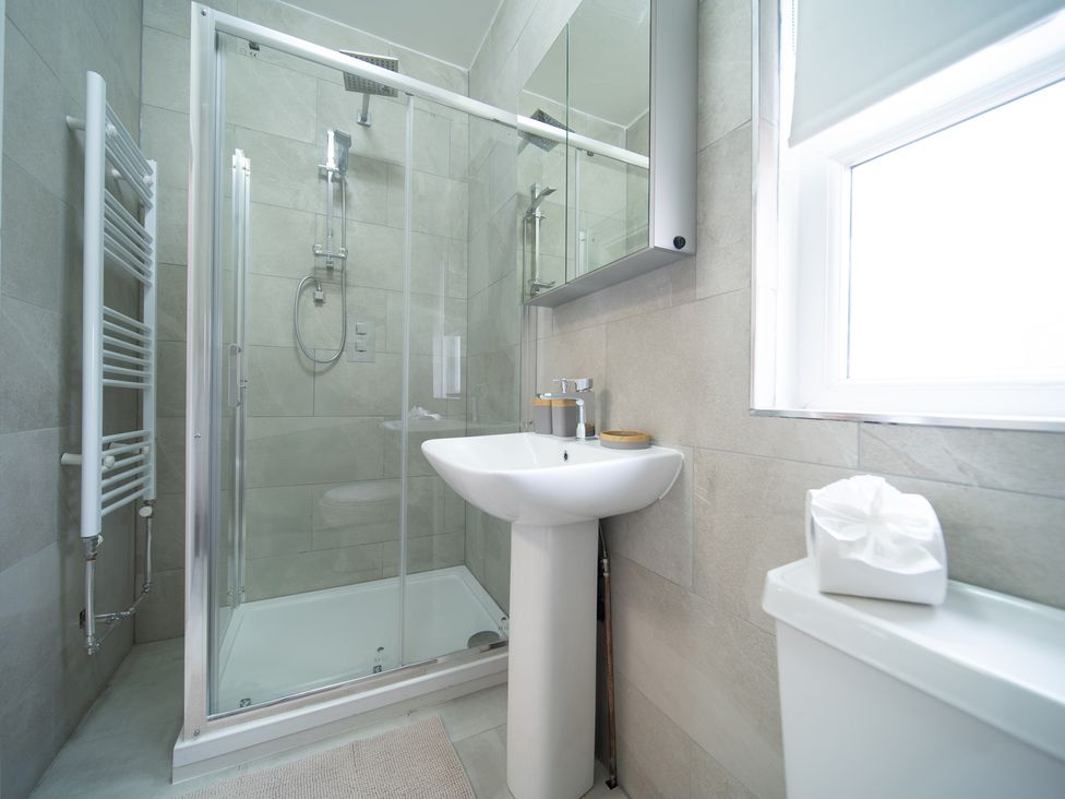 A bathroom with a shower and sink at Spacious Duplex Flat in Thornton-Cleveleys