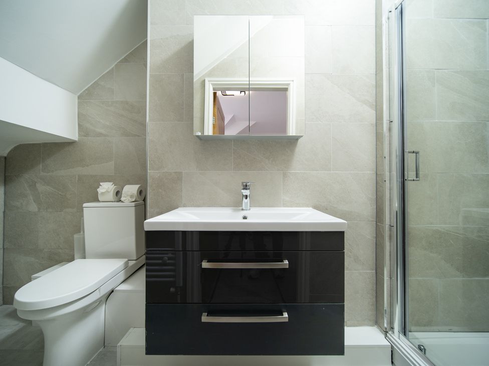 A bathroom with a sink, toilet and shower at Spacious Duplex Flat in Thornton-Cleveleys