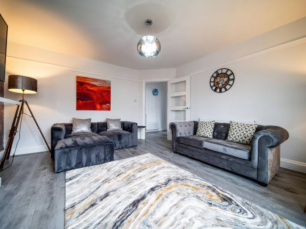 A living room with sofas and a rug at Flat with Terrace Style Rooftop in Thornton-Cleveleys