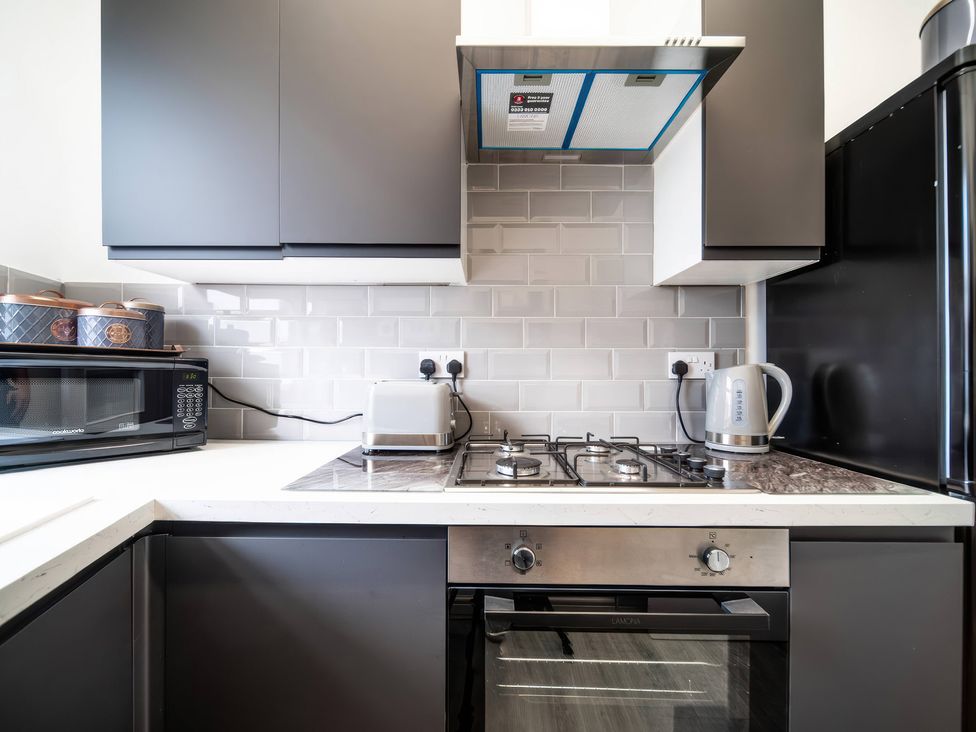A kitchen with appliances including a microwave and toaster at Flat with Terrace Style Rooftop in Thornton-Cleveleys