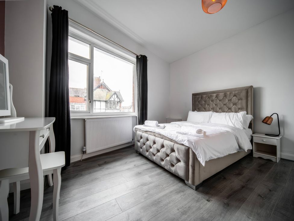 A bedroom with a bed and a desk at Flat with Terrace Style Rooftop in Thornton-Cleveleys