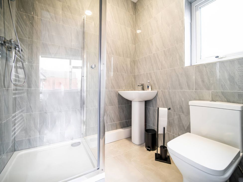 A bathroom with a shower, sink, and toilet at Flat with Terrace Style Rooftop in Thornton-Cleveleys
