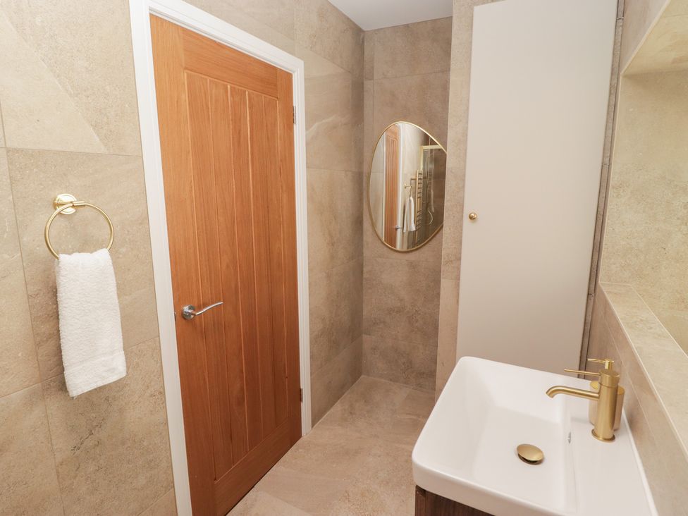 A bathroom with a sink and towel holder at Flat 3 in Tenby