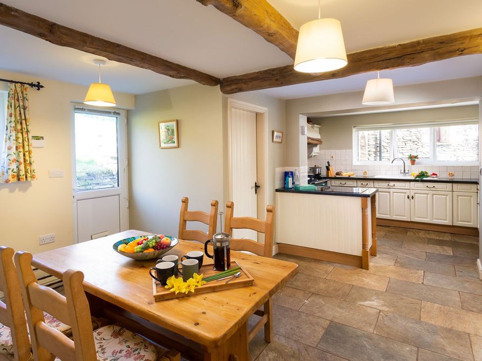 A kitchen with a dining area and counter at High Beck Kendal