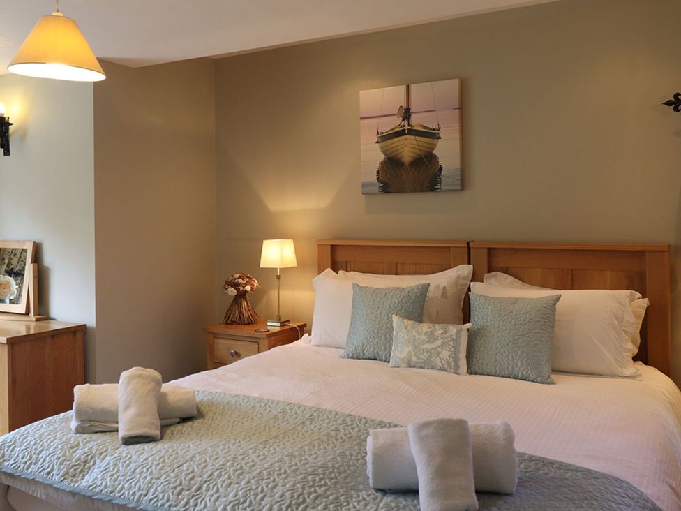 A bedroom with a bed and pillows at High Beck in Kendal