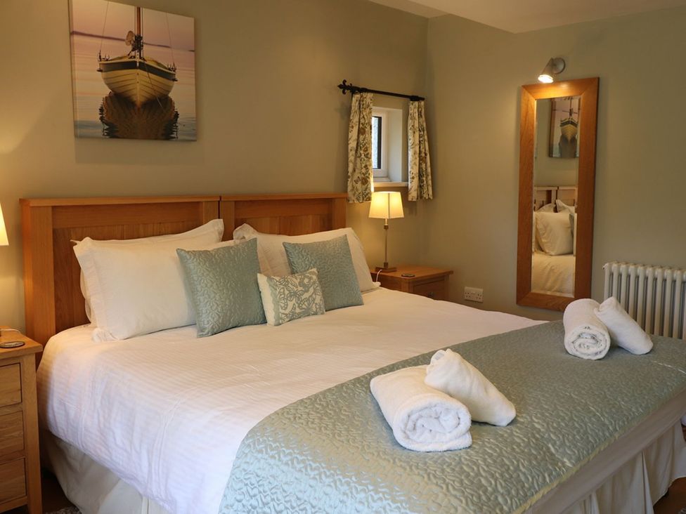 A bedroom with a bed and side tables at High Beck in Kendal