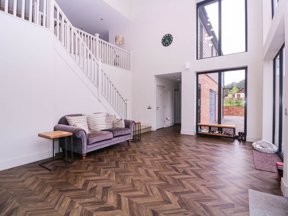 A living room with a staircase and sofa at Hanbury House in Lea