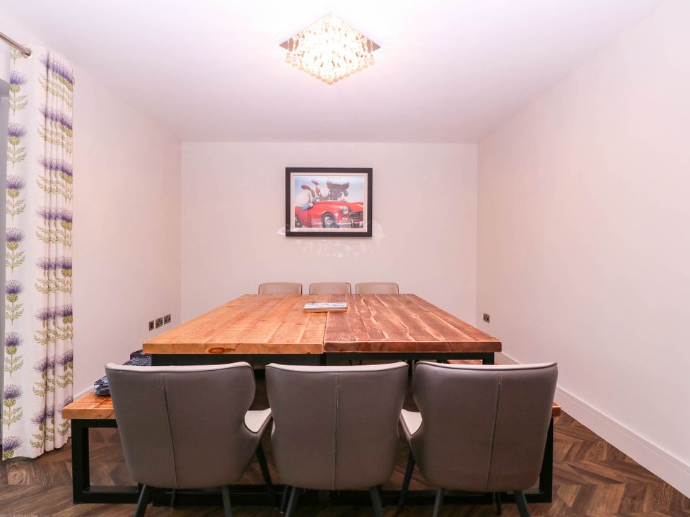 A dining room with a table and chairs at Hanbury House Lea