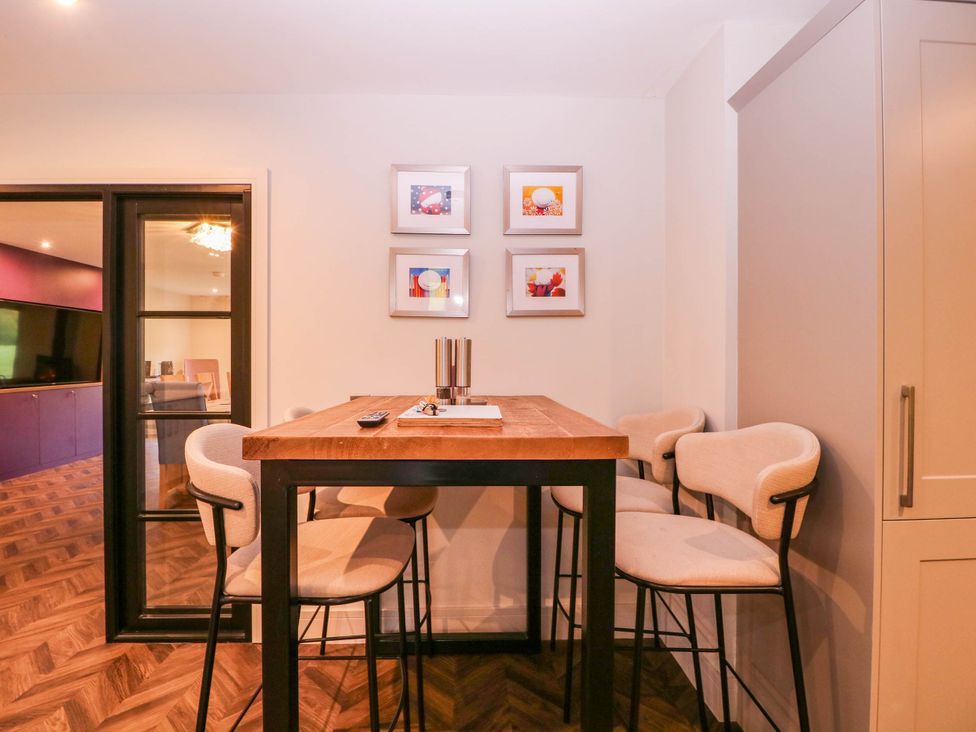A dining room with a table and chairs at Hanbury House Lea