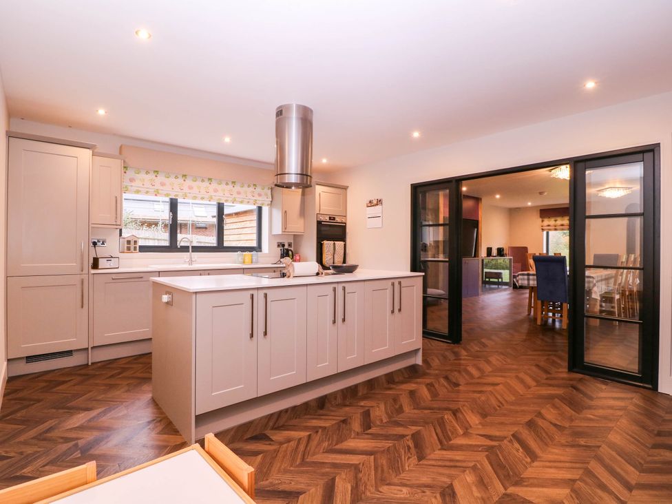 A kitchen with cabinets and an island at Hanbury House in Lea