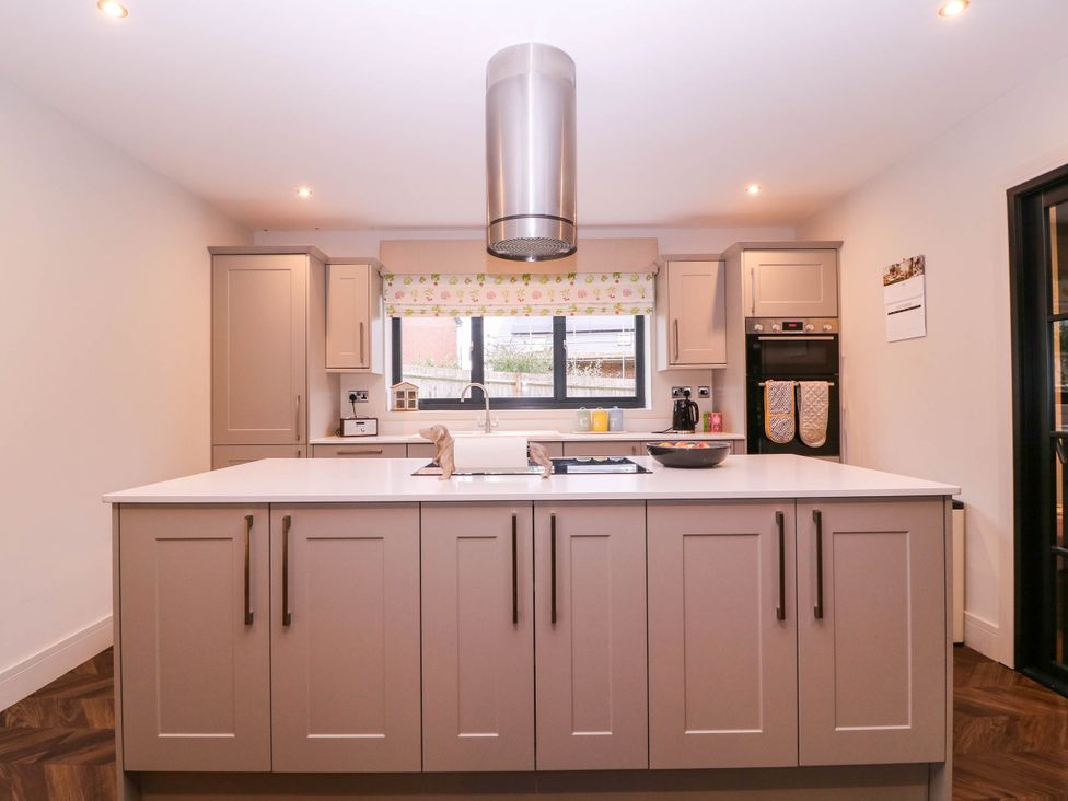 A kitchen with an island and modern appliances at Hanbury House in Lea