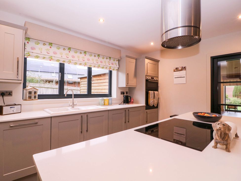 A kitchen with cabinets and a sink at Hanbury House, Lea