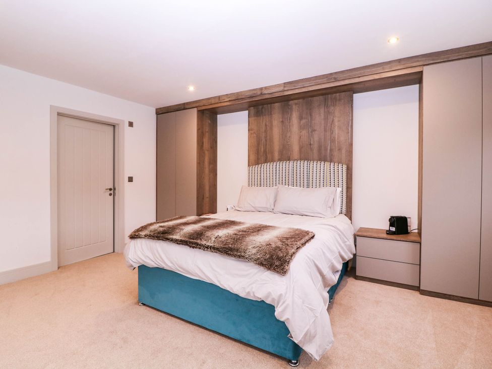 A bedroom with a bed and wardrobe at Hanbury House in Lea