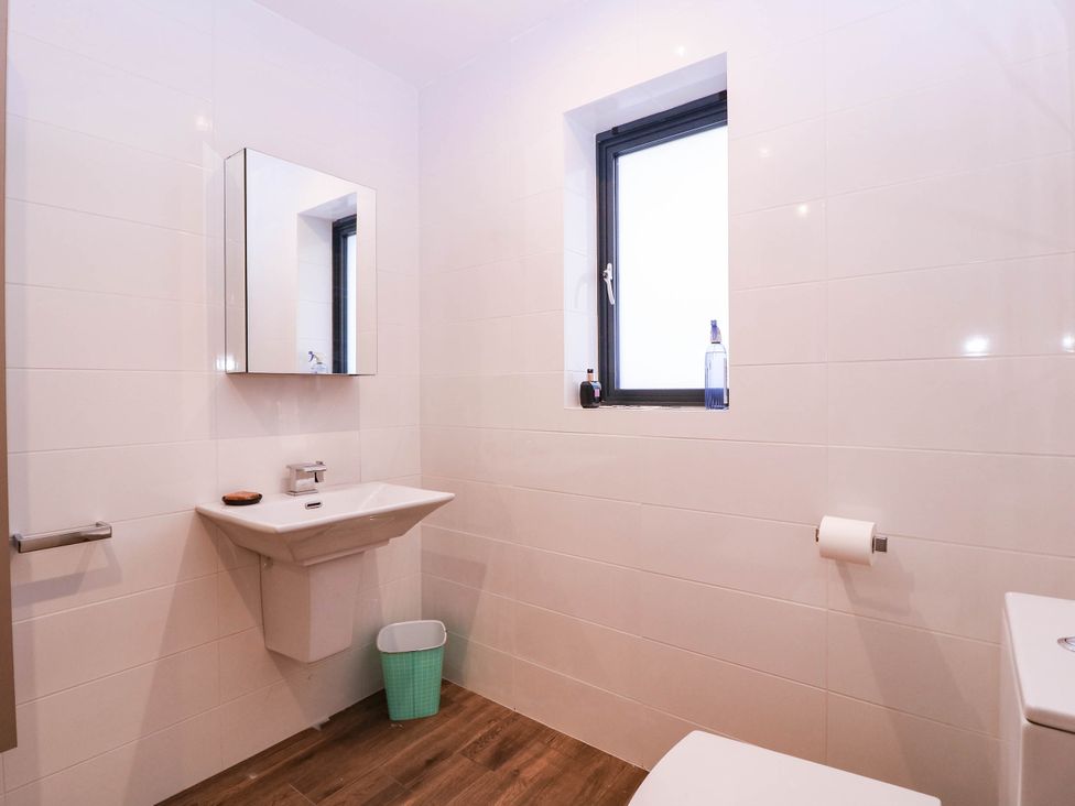 A bathroom with a sink, toilet and window at Hanbury House in Lea