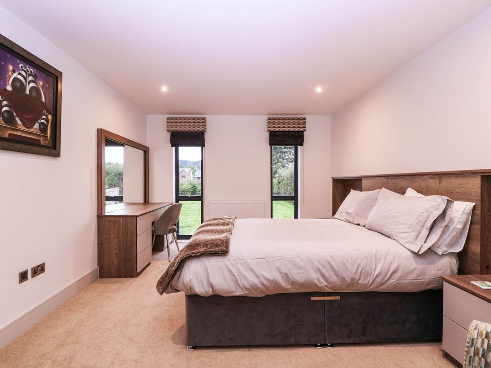 A bedroom with a bed and a dresser at Hanbury House in Lea