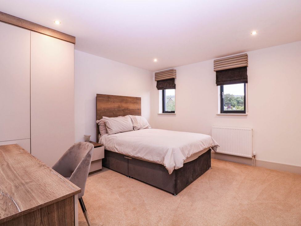 A bedroom with a bed and a desk at Hanbury House in Lea