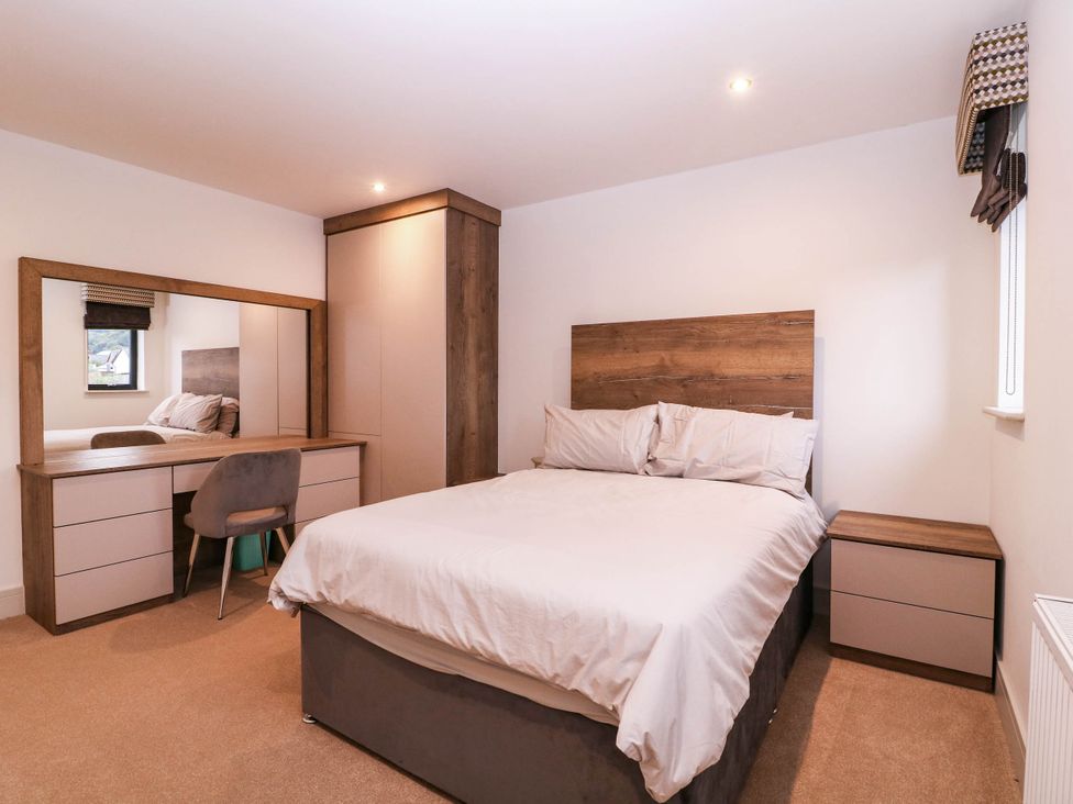 A bedroom with a bed and a desk at Hanbury House in Lea