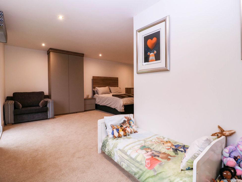 A bedroom with a bed and a sofa at Hanbury House in Lea