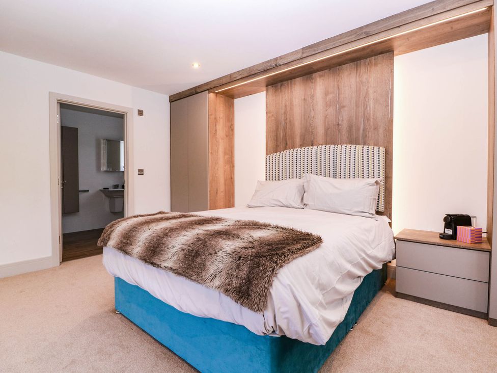 A bedroom with a bed and bedside table at Hanbury House in Lea