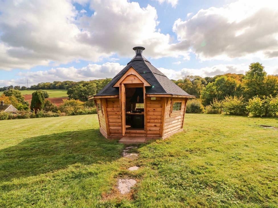 A wooden hut in a grassy area at Hanbury House, Lea