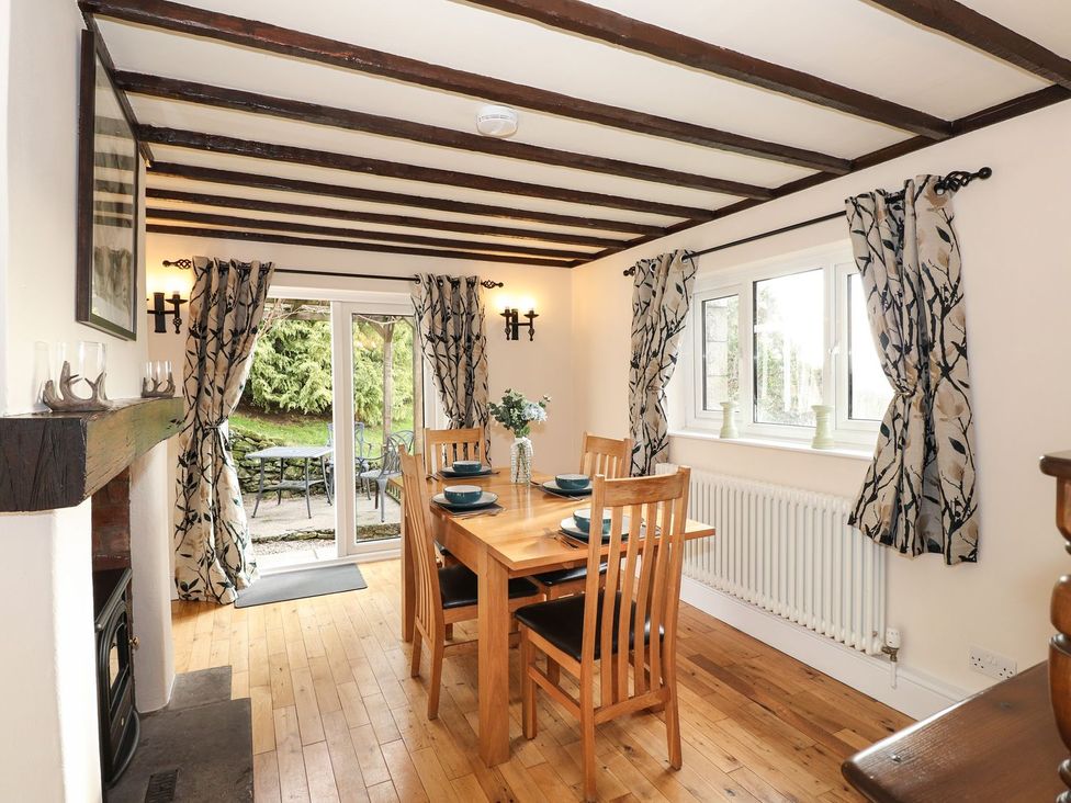 A dining room with a table and chairs at High Beck Cottage in Kendal