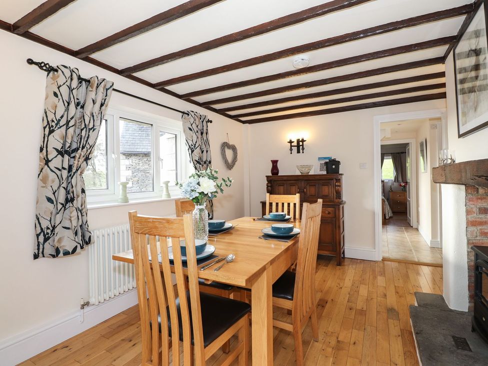 A dining room with a table and chairs at High Beck Cottage in Kendal