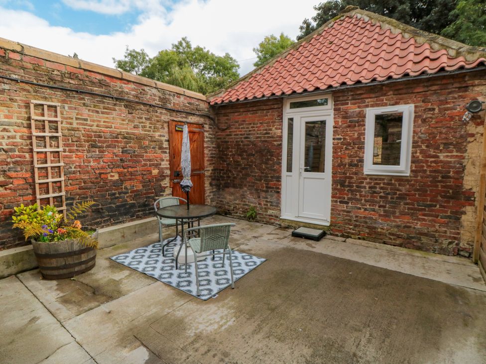 An outdoor area with a table and chairs at The Guest Room in Redcar