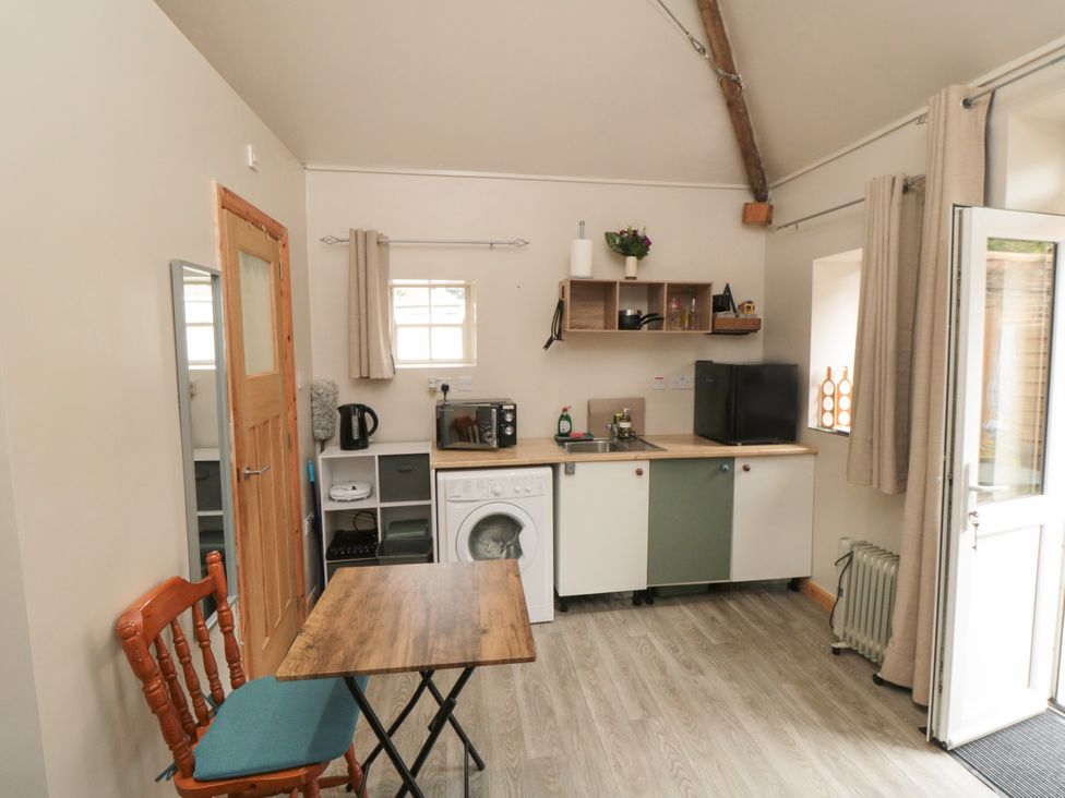 A kitchen with a table, chair, and appliances at The Guest Room in Redcar