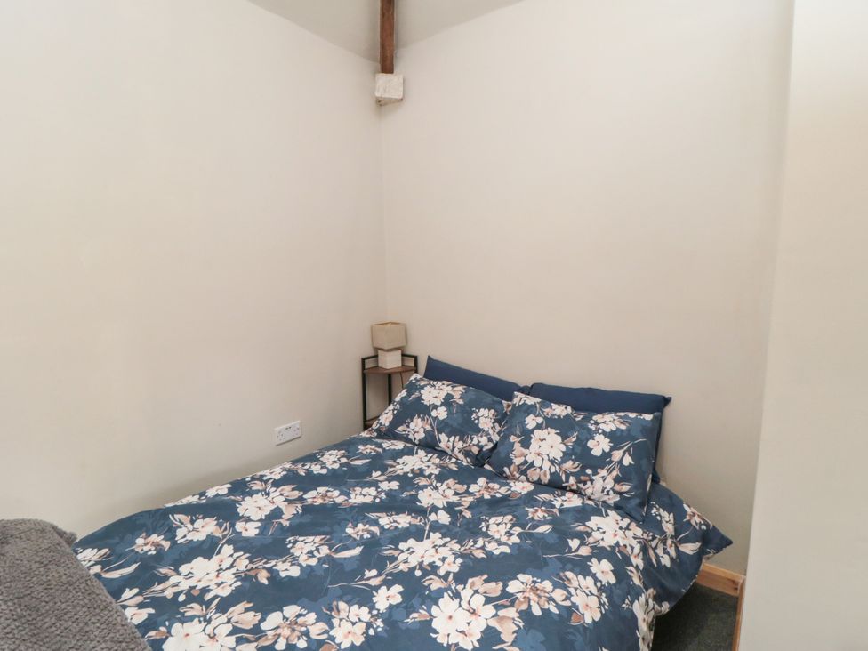 A bedroom with a bed and nightstand at The Guest Room in Redcar