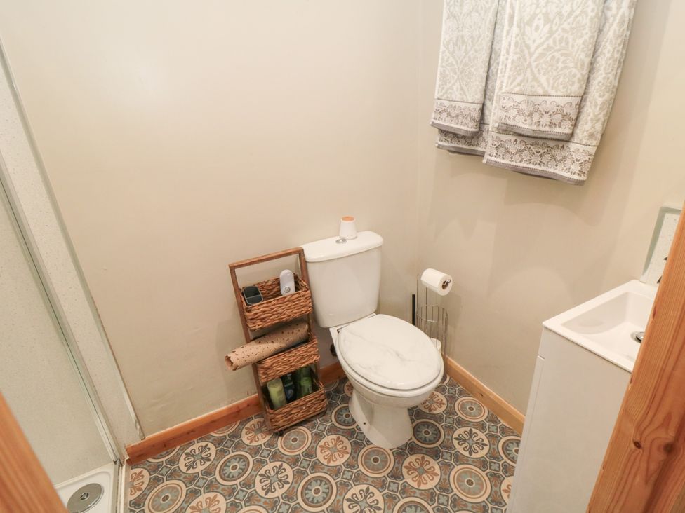 A bathroom with a toilet, sink, and shower at The Guest Room in Redcar
